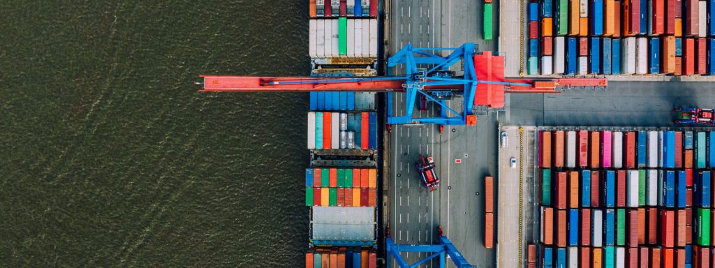 cargo containers being unloaded from a vessel