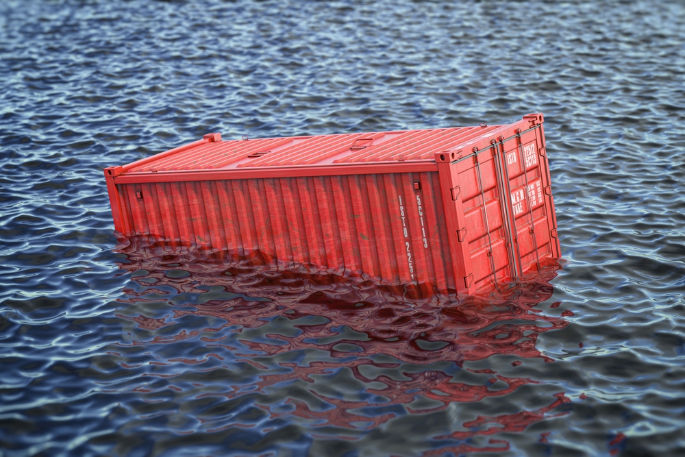 shipping container overboard drifting in the water